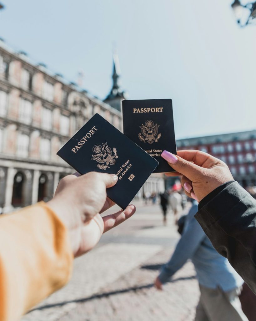 person-holding-passports-0qcsncm0amc